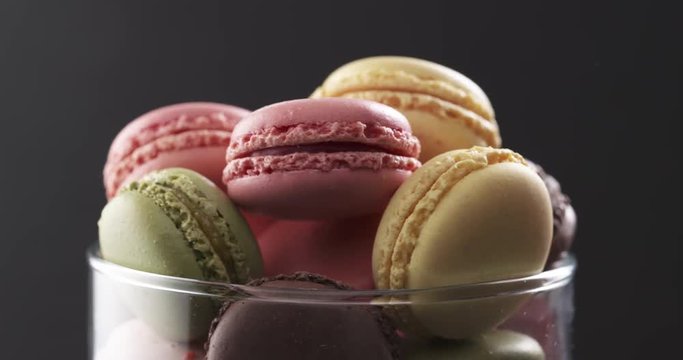 mixed macarons in glass bowl rotating loopable video, 4k prores footage