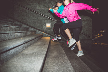 Three women running in the night in the city center