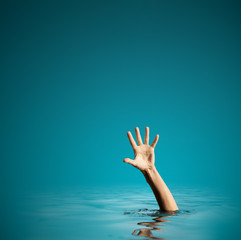 Hand on sea water background asking for help