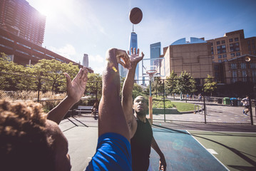 Fototapeta premium Two street basketball players playing hard on the court