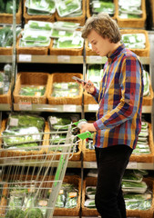 Young man buying vegetables at the market   .Young man in the supermarket .