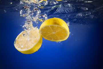 Fresh lemon dropped into water.
