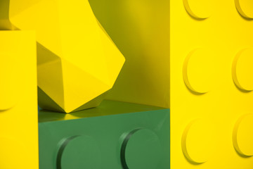 Yellow and green blocks on blue background. Toys for kid photography. 