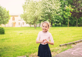 Happy preteen girl running on meadow in summer day at sunset