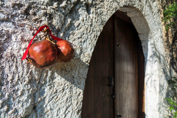 Two pomegranates for good luck on traditional wooden door in Peloponnese, Greece