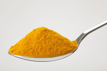 spoon of ground, powder turmeric
