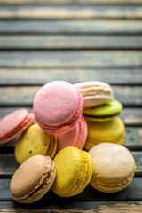 Colorful macaroons on wooden background
