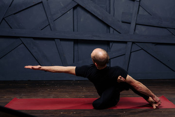 Man practicing advanced yoga against a urban background