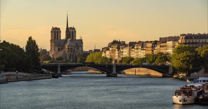 Time lapse of Notre Dame de Paris Cathedral, Ile Saint Louis and the Seine River with passing tourist boats on a Summer afternoon. 4th Arrondissement, Paris, France