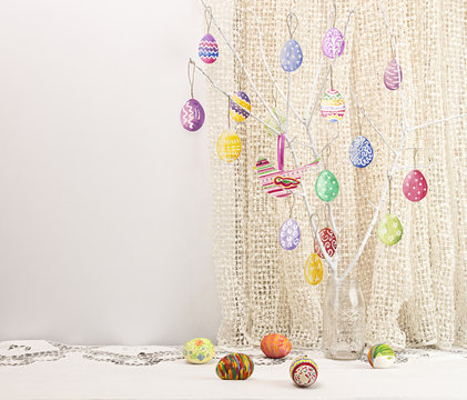Easter holiday background with branch, painted Easter eggs and bird