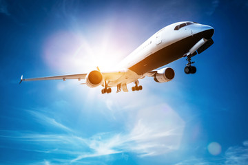 Fototapeta na wymiar Passenger airplane taking off, sunny blue sky.