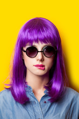 photo of beautiful young woman in wig on the wonderful yellow background