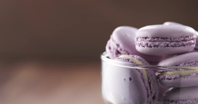 lavender violet macarons in glass bowl rotating loopable video, 4k prores footage