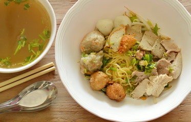 Chinese yellow noodles topping shrimp ball and slice boiled pork with soup