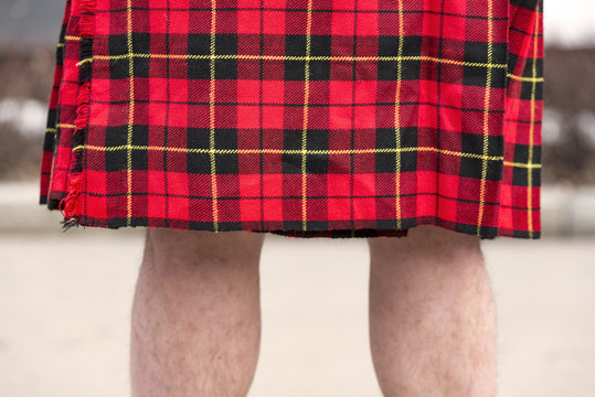 Legs Of A Man In Scottish Red Kilt