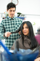 Professional hairdresser working in the hairdressing salon.