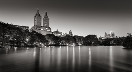 Fototapeta na wymiar Central Park and city lights across The Lake at twilight. Black & White. Upper West Side, Manhattan, New York City