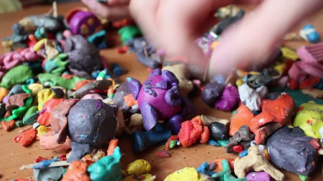 Boys playing with colorful plasticine