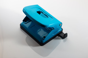 Isolated blue paper punch against a white background