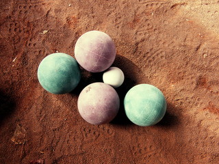 Bocce balls on a sand court