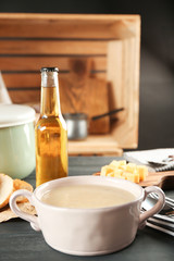 Delicious cream soup in pan on table