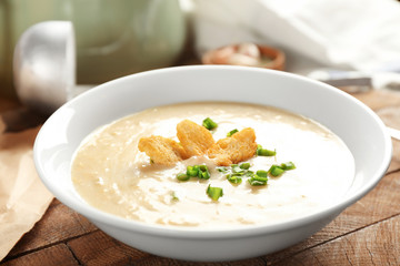 Delicious cream soup with bread on table
