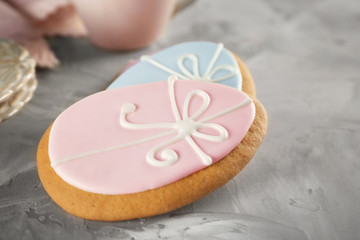 Creative egg shape Easter cookies on gray background