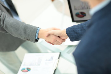 businessman shaking hands to seal a deal with his partner