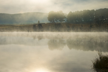 Early morning misty reflections in a lake at Underberg in the Drakensberg region of South Africa.