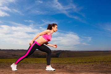 young woman running on blue sky background