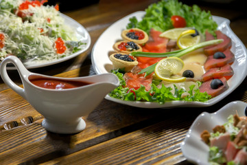 Table with food and glasses of juice, hands of eating people