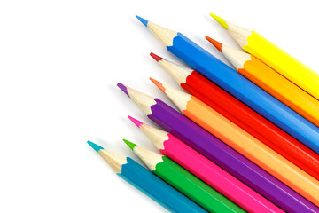 Chaotically placed wooden color pencils on a white background, top view