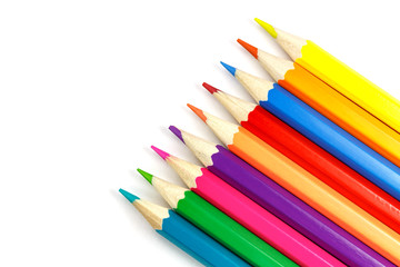 Wooden color pencils on a white background, top view