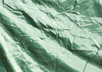 Green crumpled fabric as background