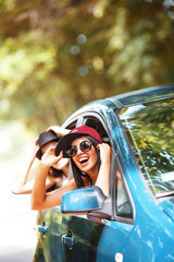 Driving in the car, two friends share laughter and joy, creating memorable moments on the road.