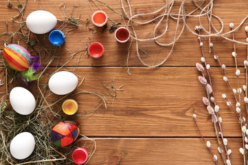 Painting colorful easter eggs background, top view on wood