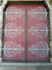marseille cathedral red wood doors  with ornate scroll leaf design hinges