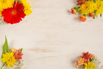 Composition of  bright flowers on a wooden table