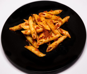 Italian food - Penne al'arrabbiata (Angry Pens), a classic italian pasta recipe with spicy tomato sauce, red hot peppers and parsley.