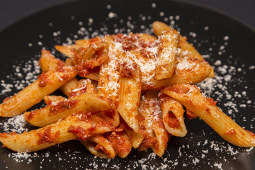 Italian food - Penne al'arrabbiata (Angry Pens), a classic italian pasta recipe with spicy tomato sauce, red hot peppers and parsley.