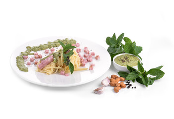Italian pasta spaghetti with pesto sauce and basil leaf