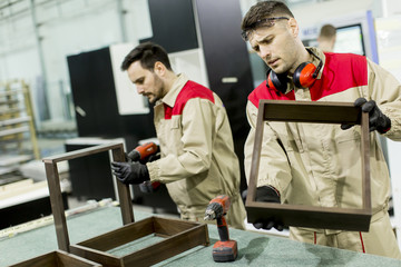 Fototapeta premium Workers in the furniture factory