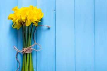 Spring background with daffodils on wooden table