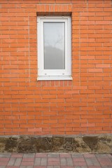 red brick house with white window with stone