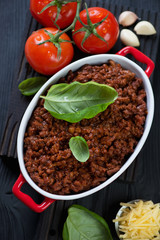 Oval casserole with freshly cooked bolognese sauce, view from above, studio shot