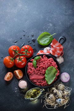 Ingredients for preparing bolognese sauce, high angle view with copyspace, studio shot