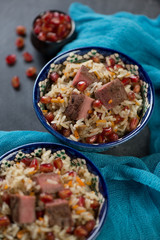 Georgian style pilaf with beef meat and pomegranate, close-up, selective focus