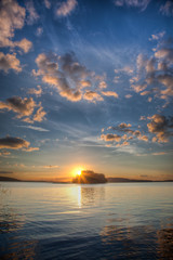 Naklejka premium Sundown and island