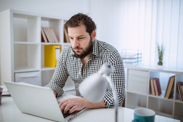 Bearded hipster in office