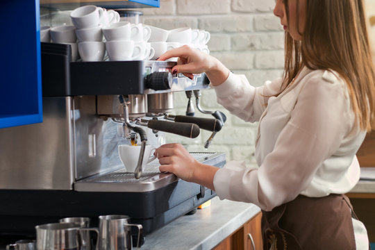young girl preparing coffee in a cafe barista